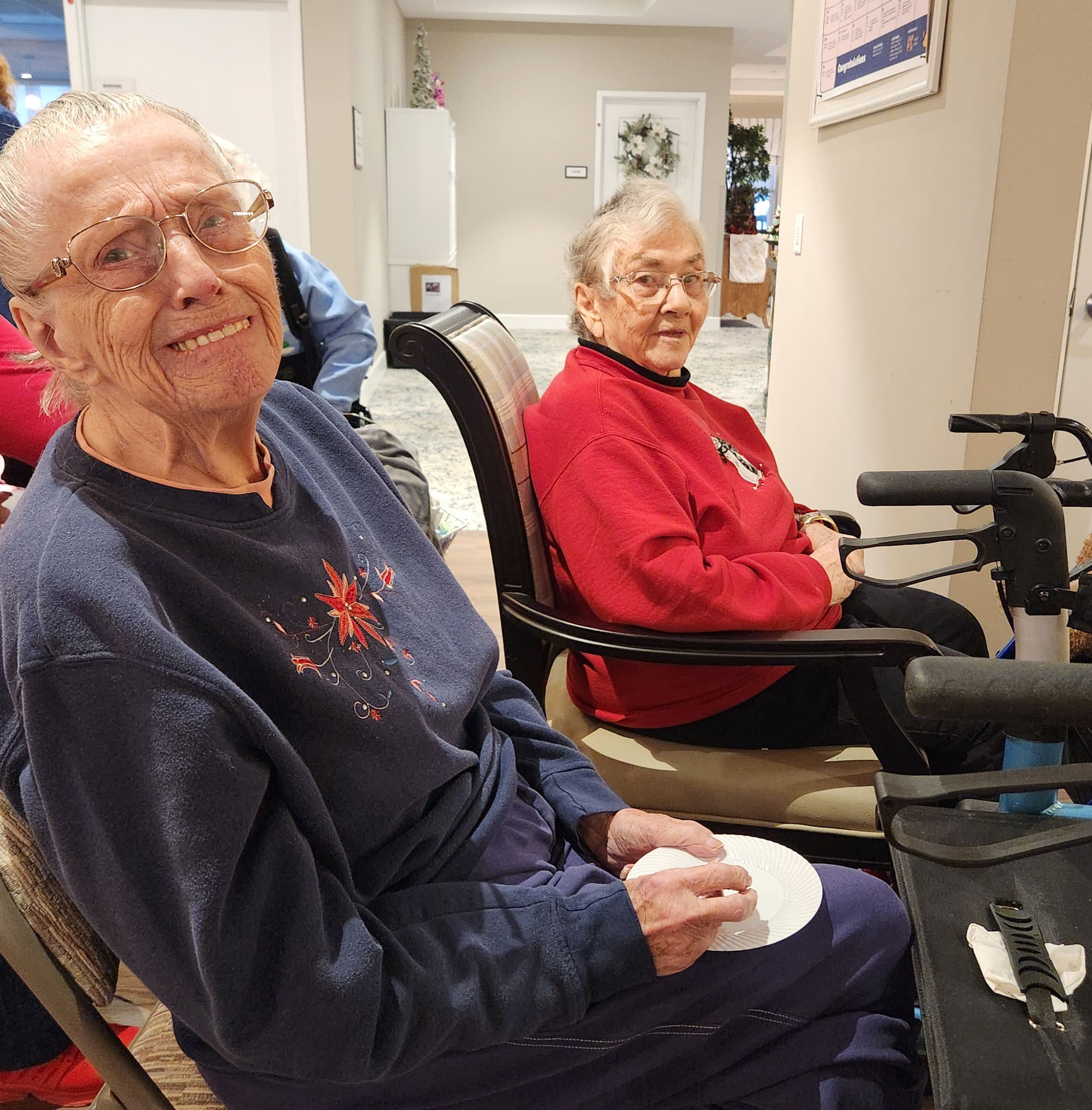 Two smiling residents in a common area.