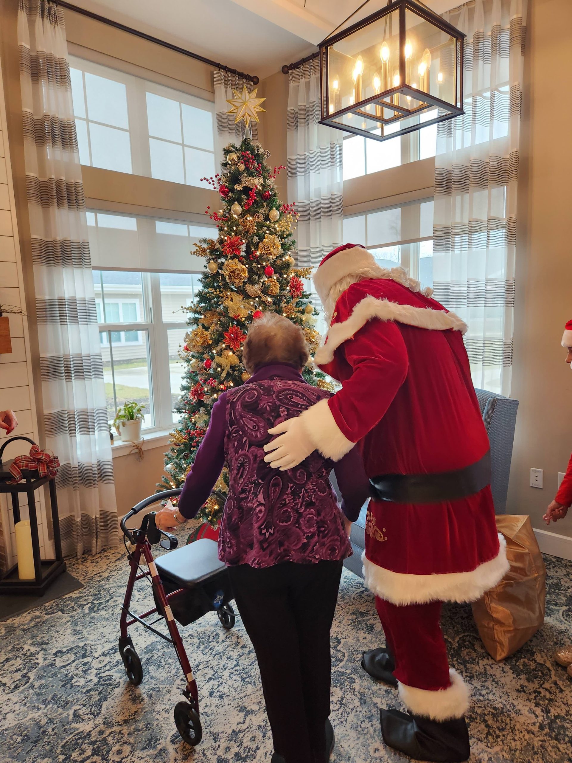 Resident interacting with Santa in holiday decor