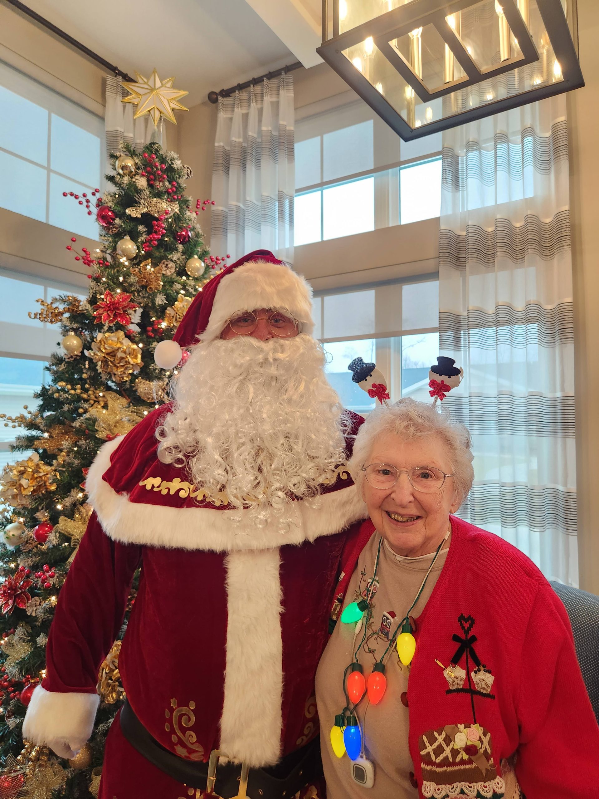 Resident with Santa in a festive interior