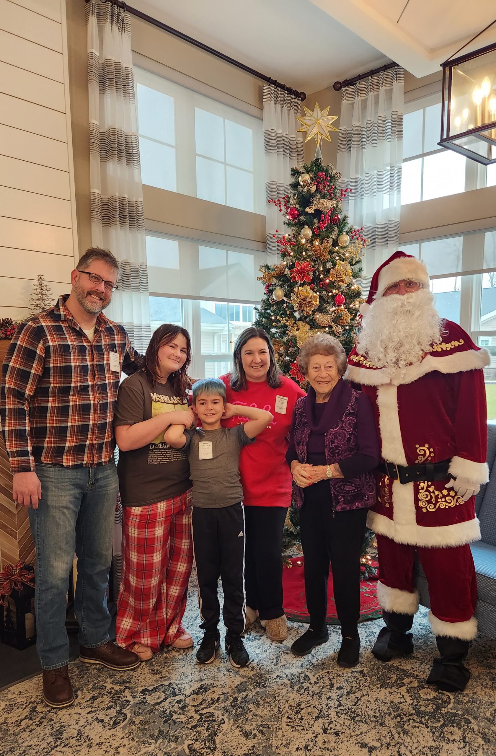 Residents celebrating with Santa near a Christmas tree