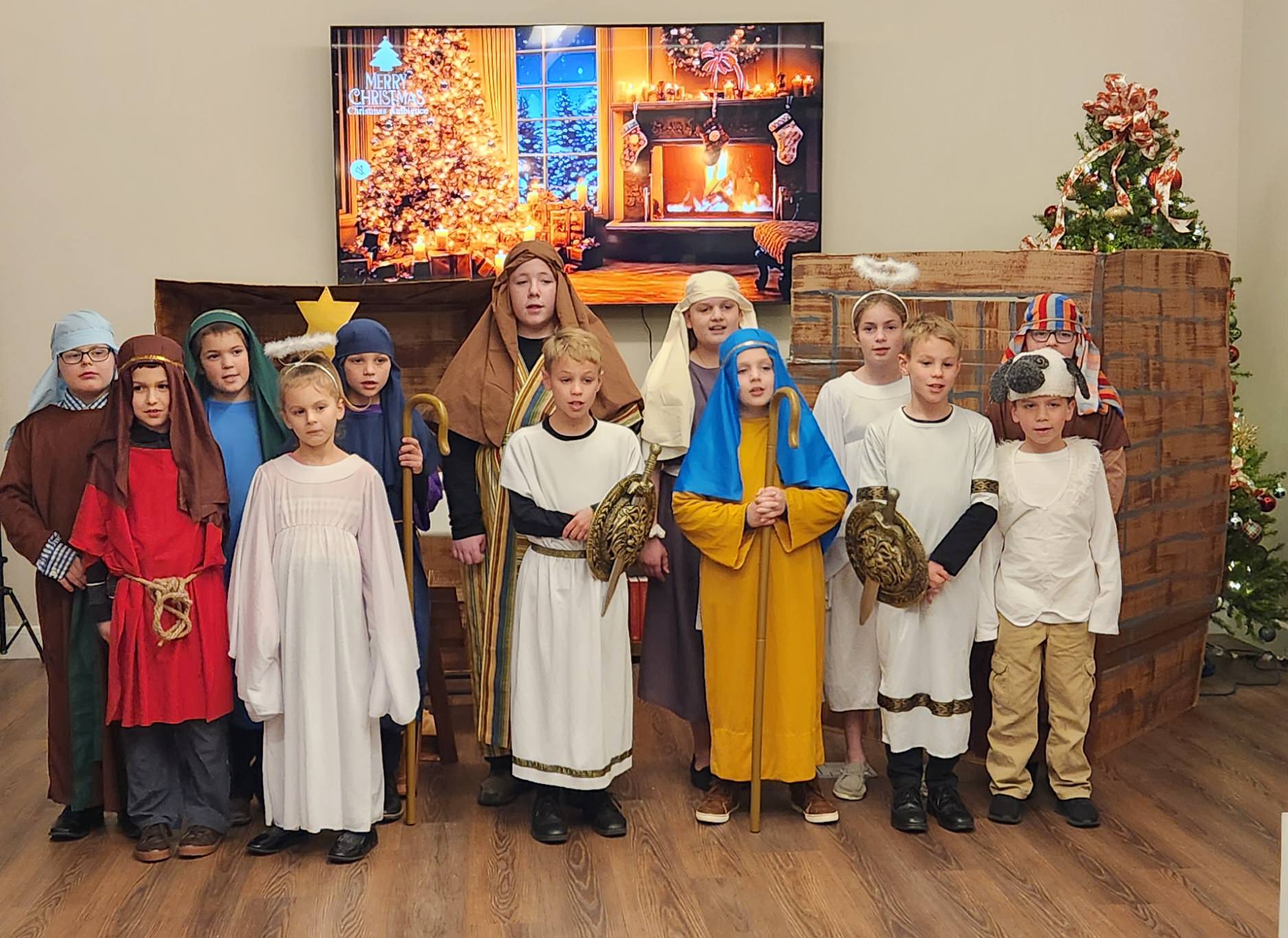Children performing a holiday play in a festive setting.