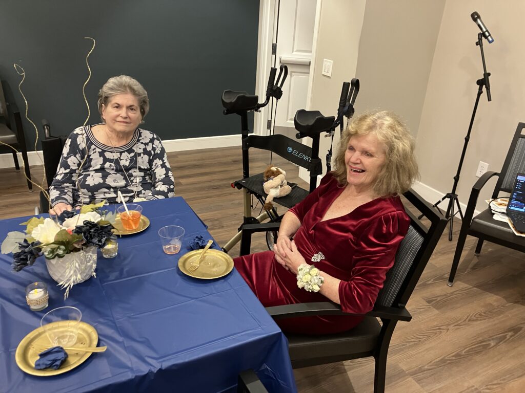 Two residents enjoying a festive gathering.