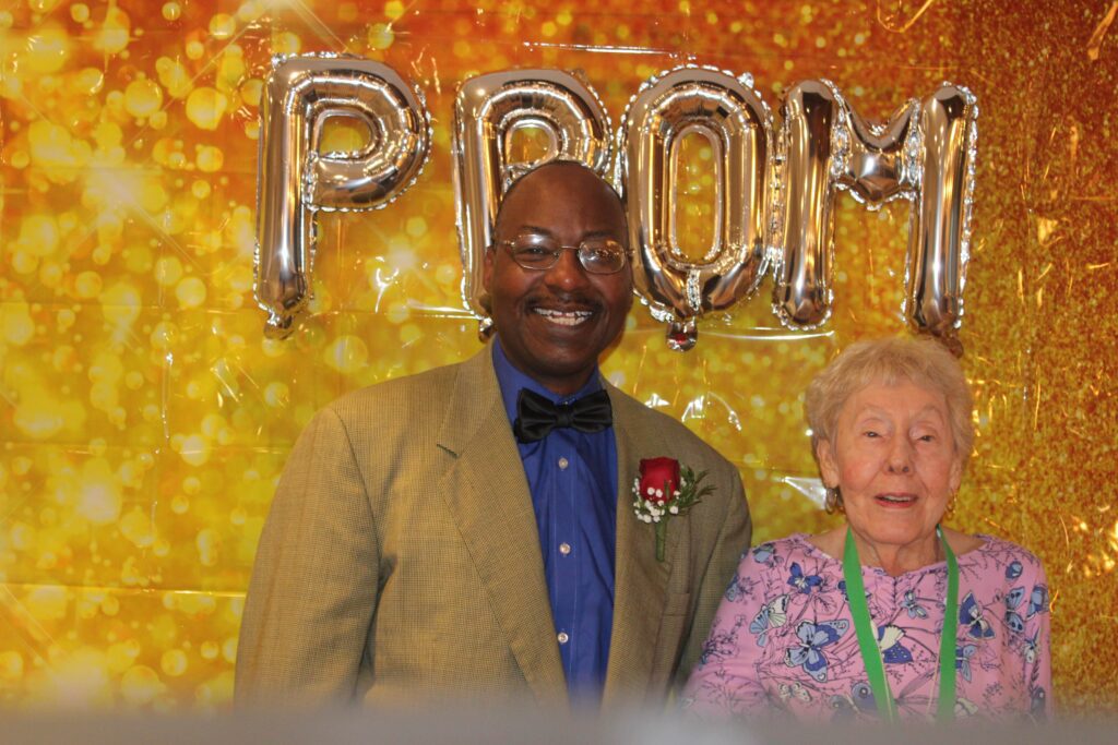 Resident and staff member at a themed event