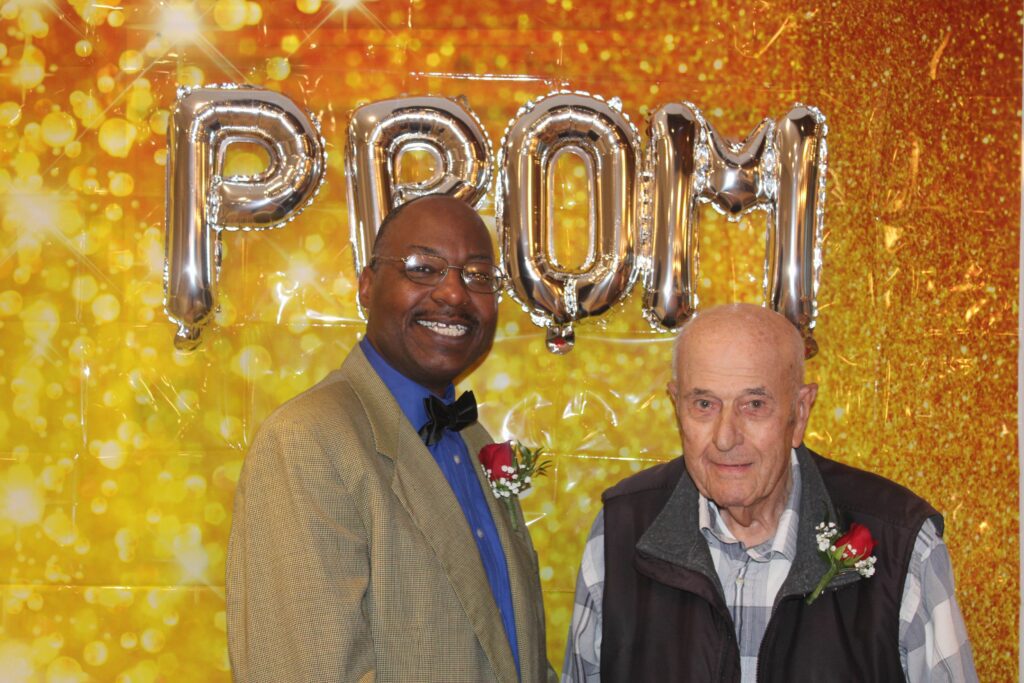 Two men celebrating with party decorations