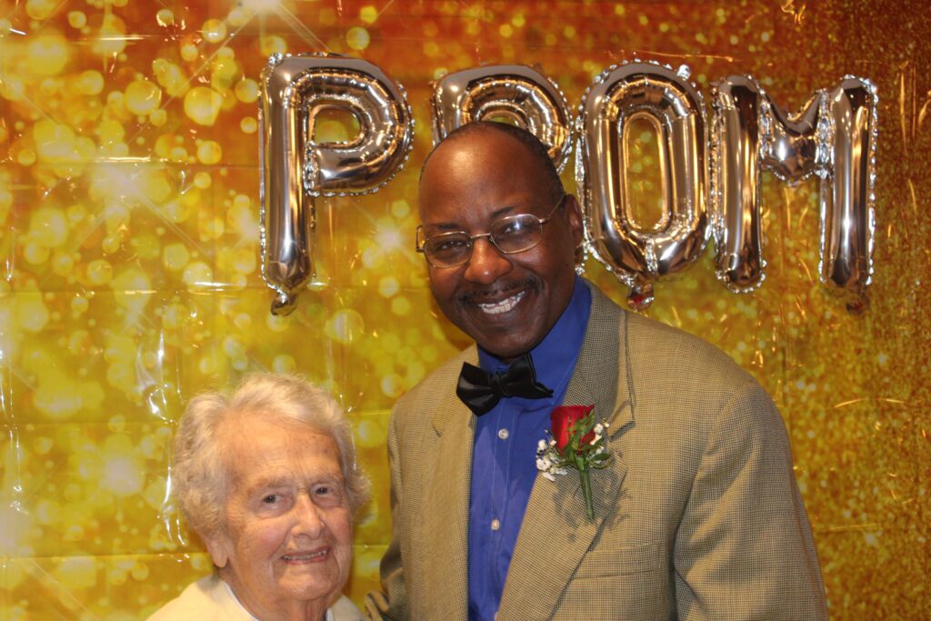 Resident and staff member at a prom event