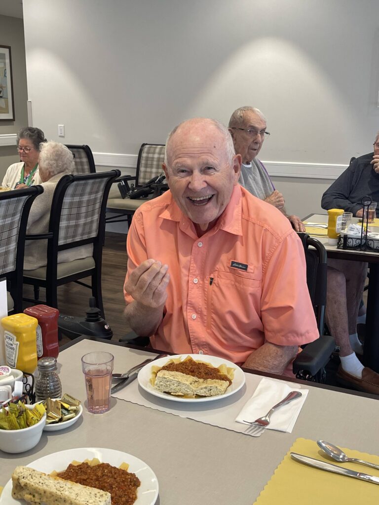 Resident enjoying a meal in the dining area