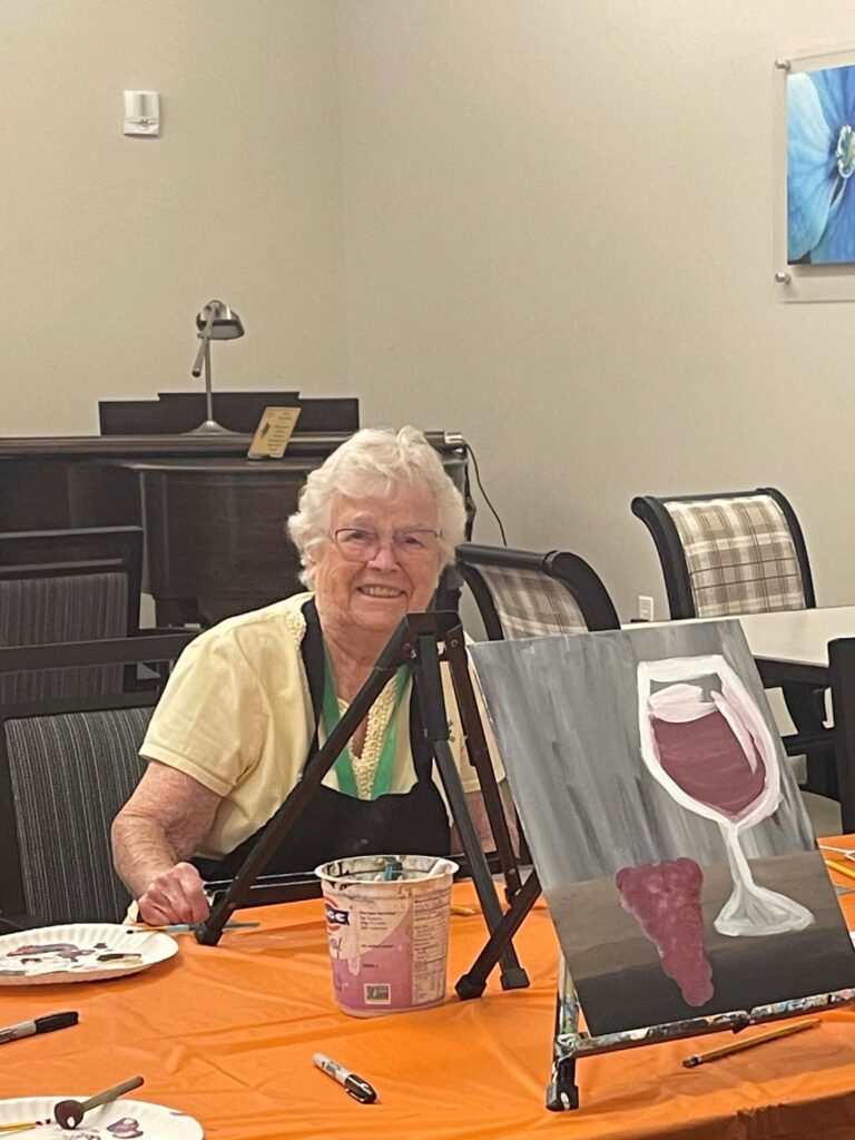 Senior resident enjoying a painting activity.