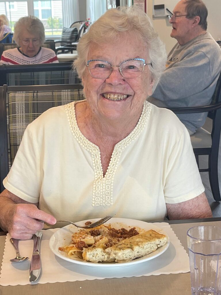 Resident enjoying a meal in the dining area.
