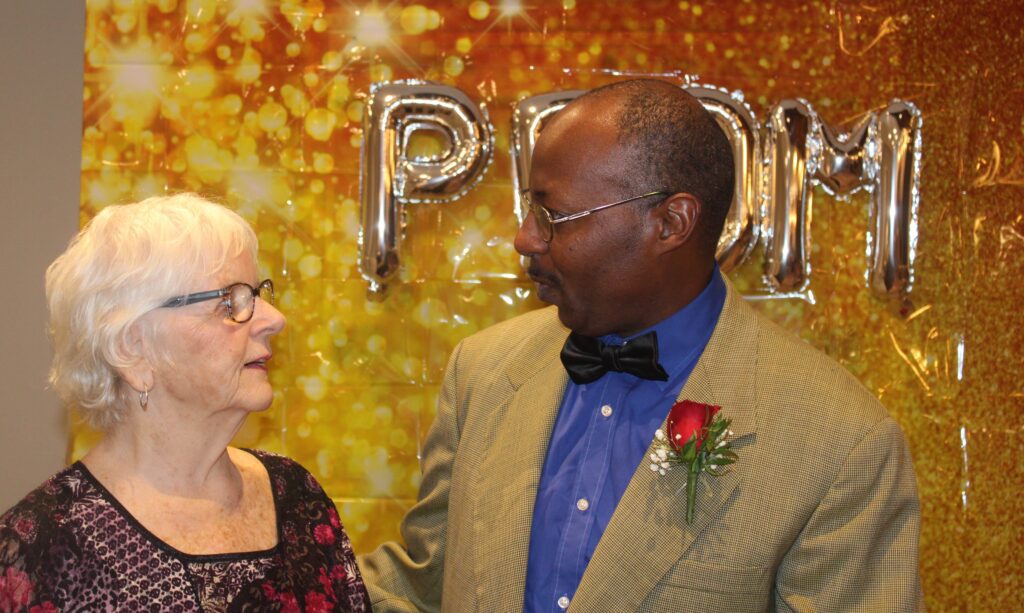 Resident and staff member engaging at an event.
