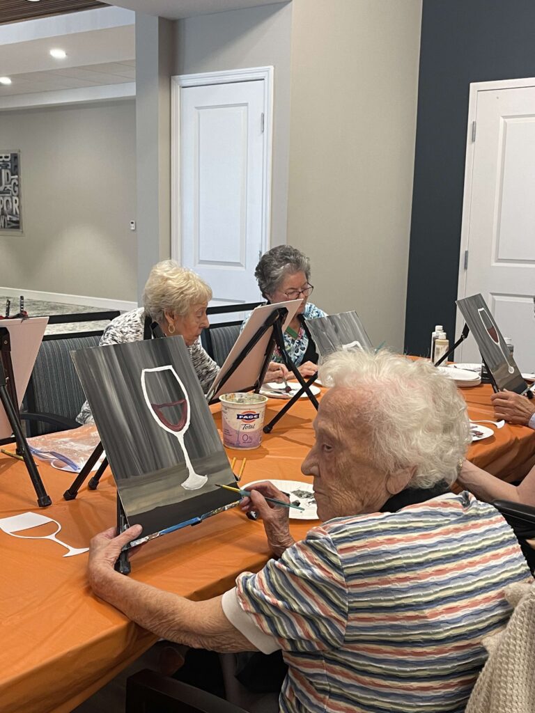 Residents participating in a painting activity
