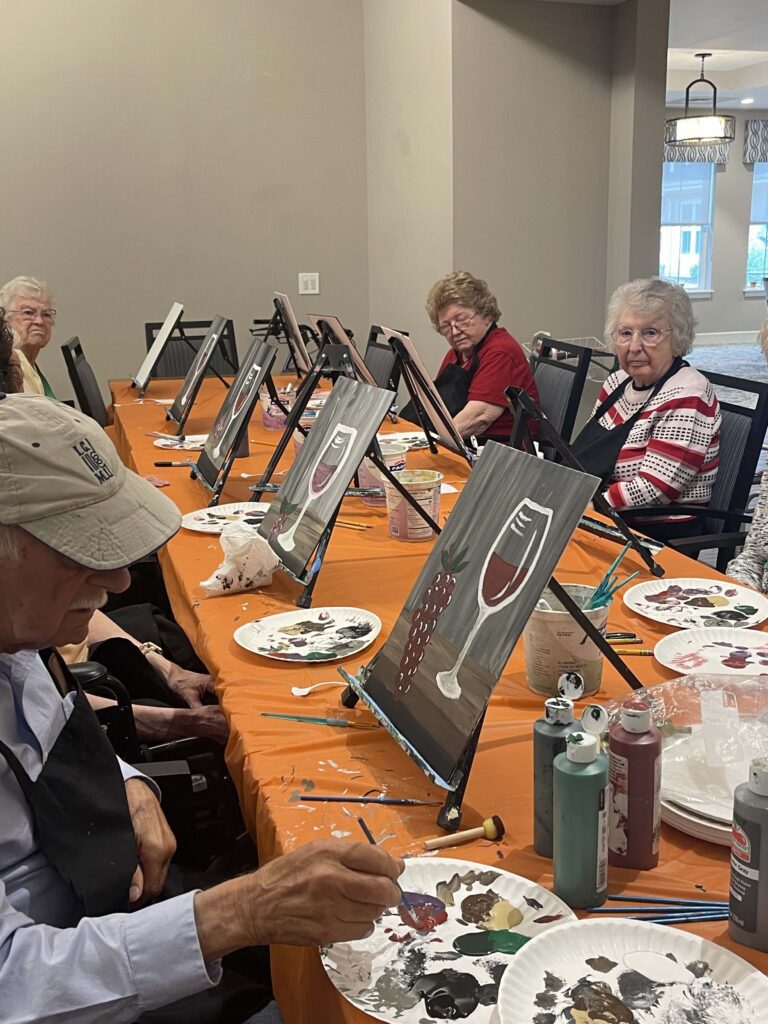 Residents participating in a painting activity