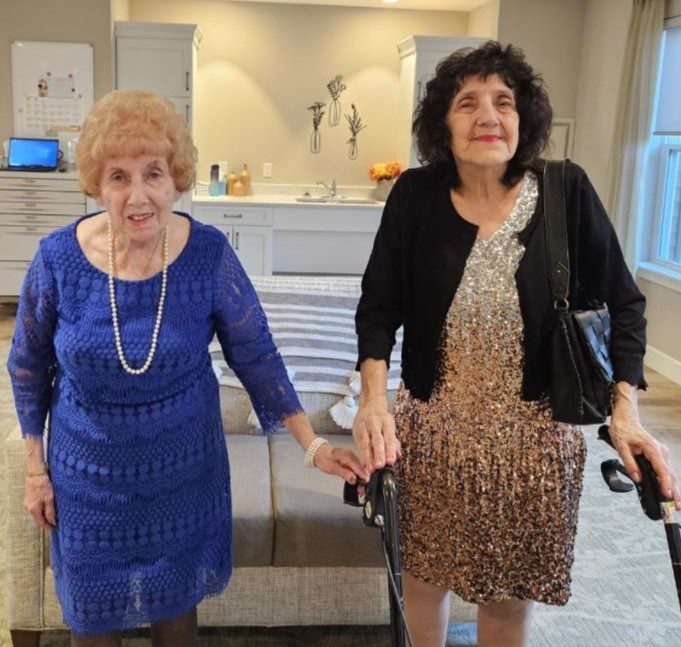 Two elderly women in a common area.