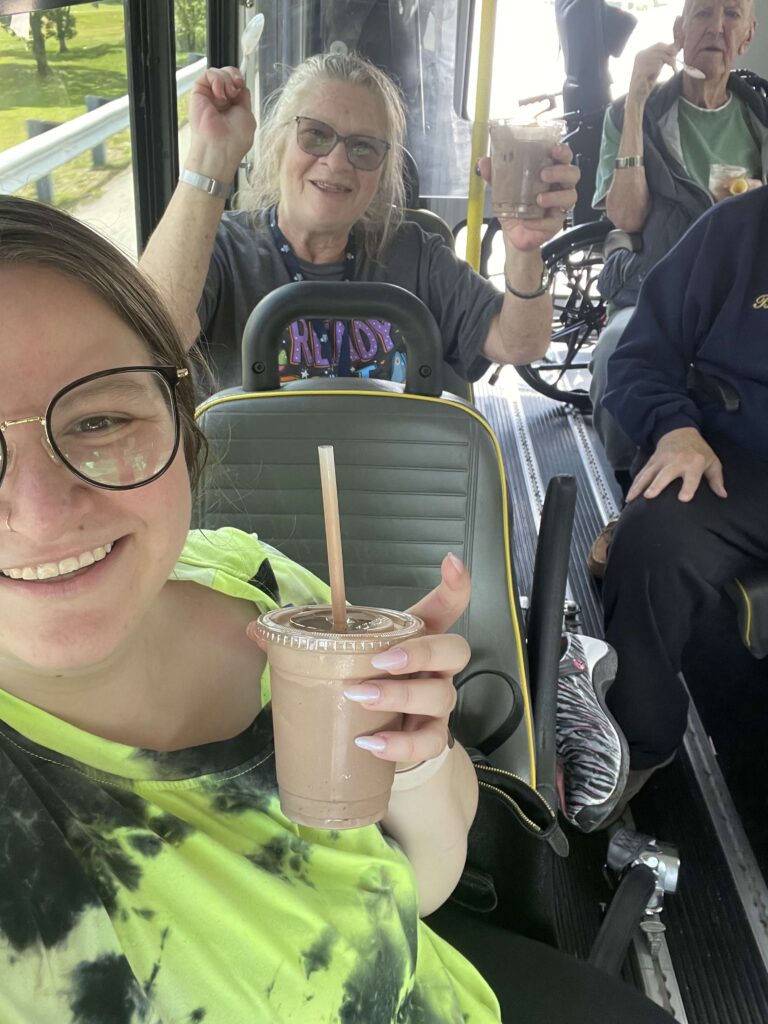 Residents enjoying drinks on a facility bus.