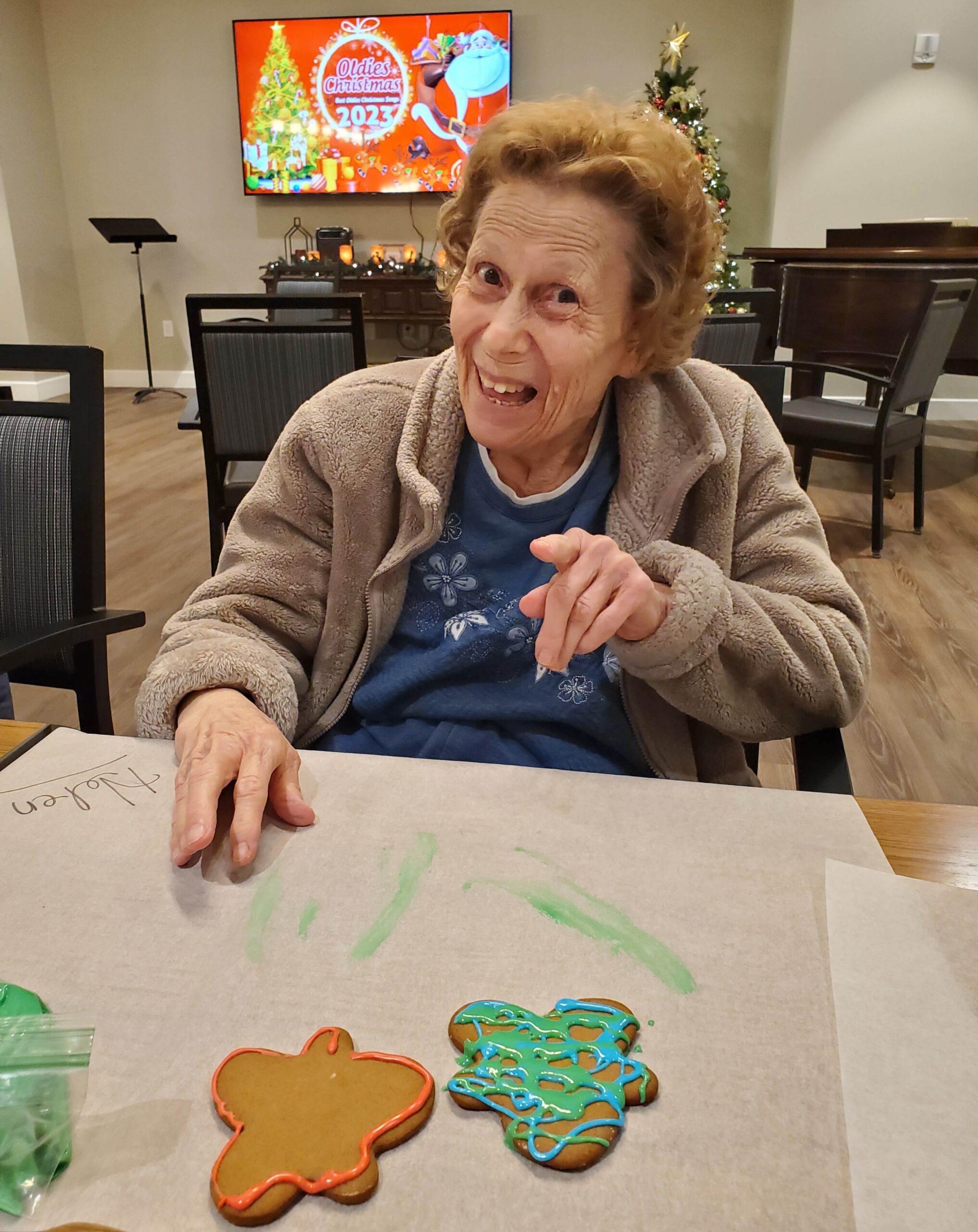 Resident decorating gingerbread cookies for Christmas.