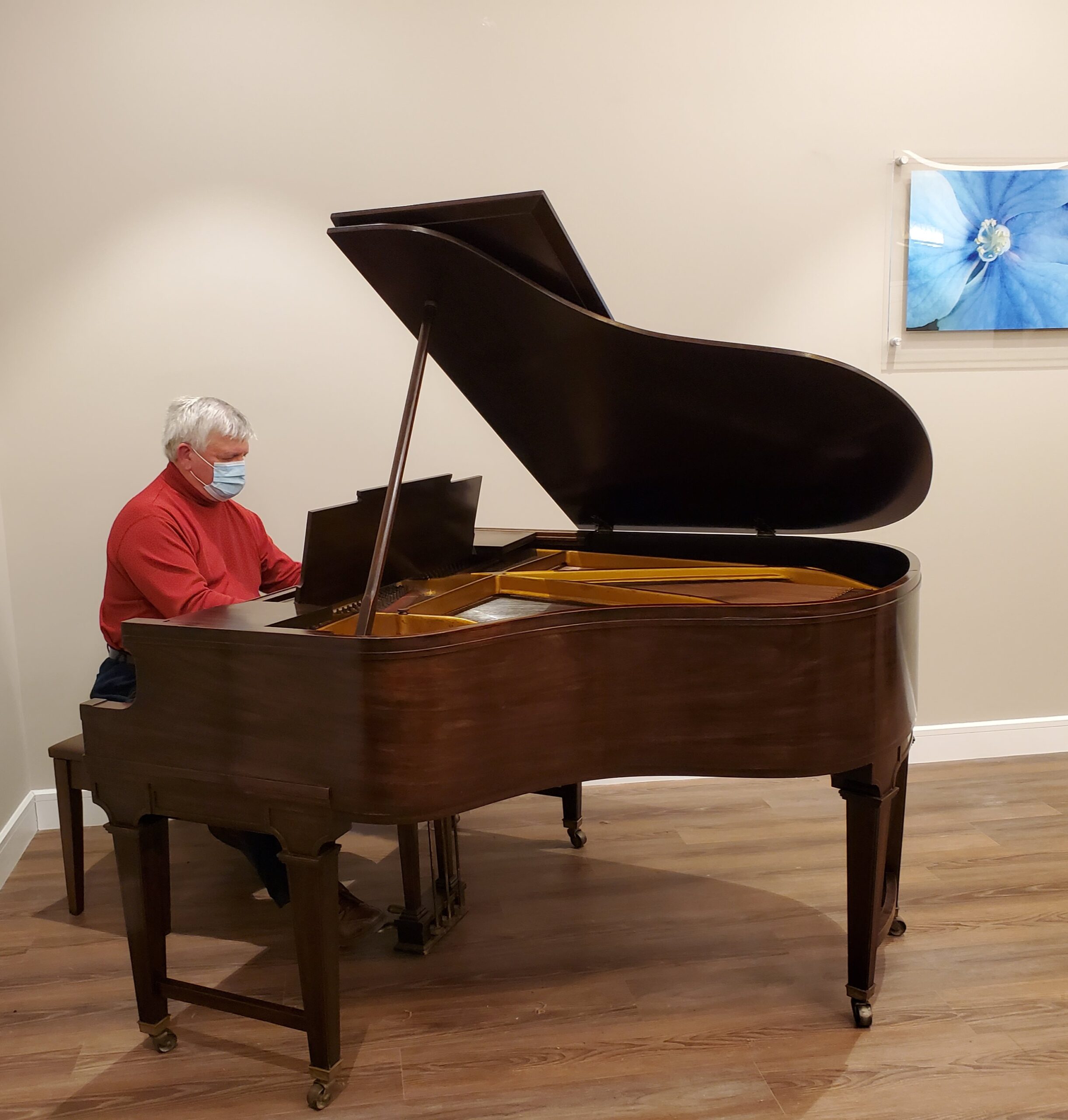Resident playing piano in a common area