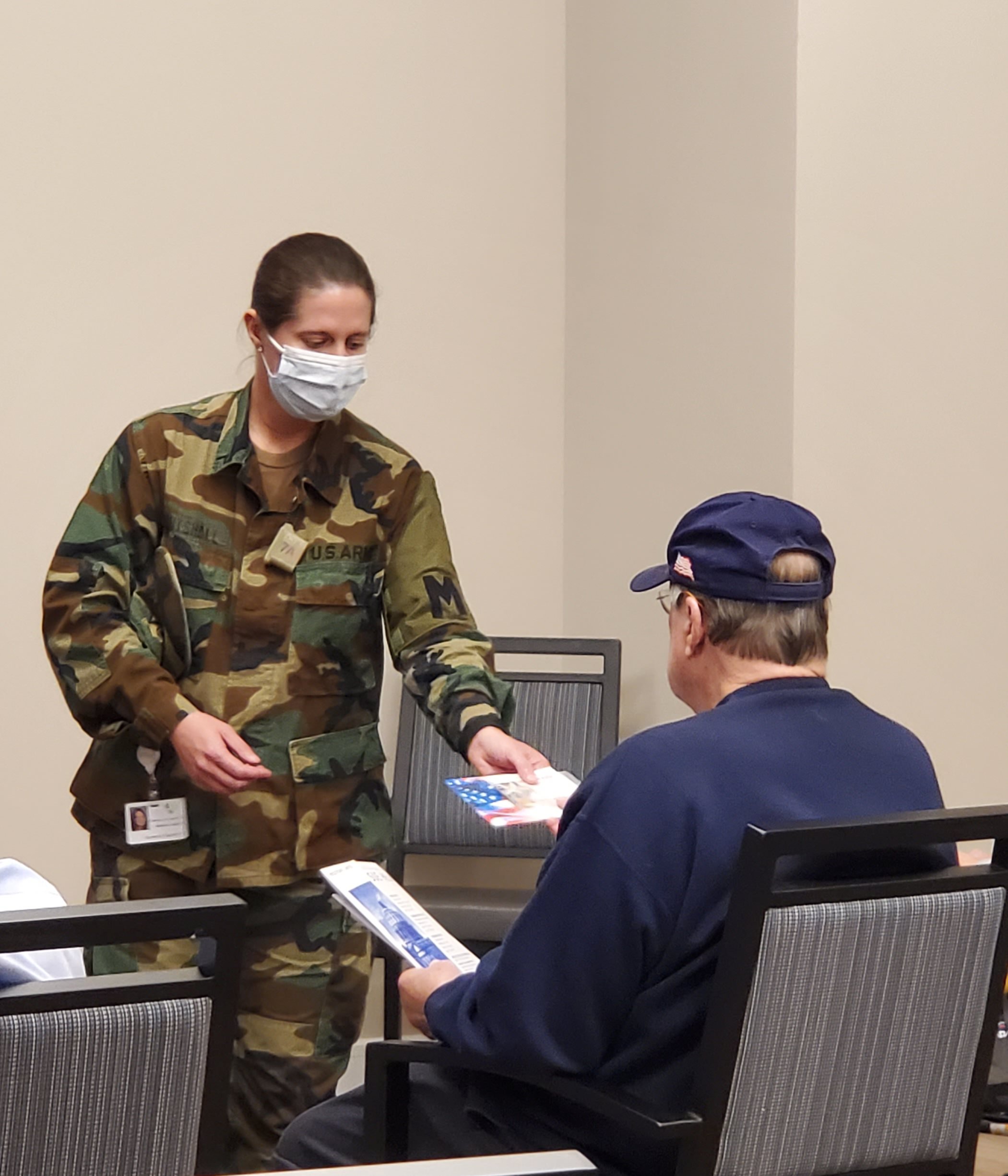 A staff member interacting with a resident indoors.
