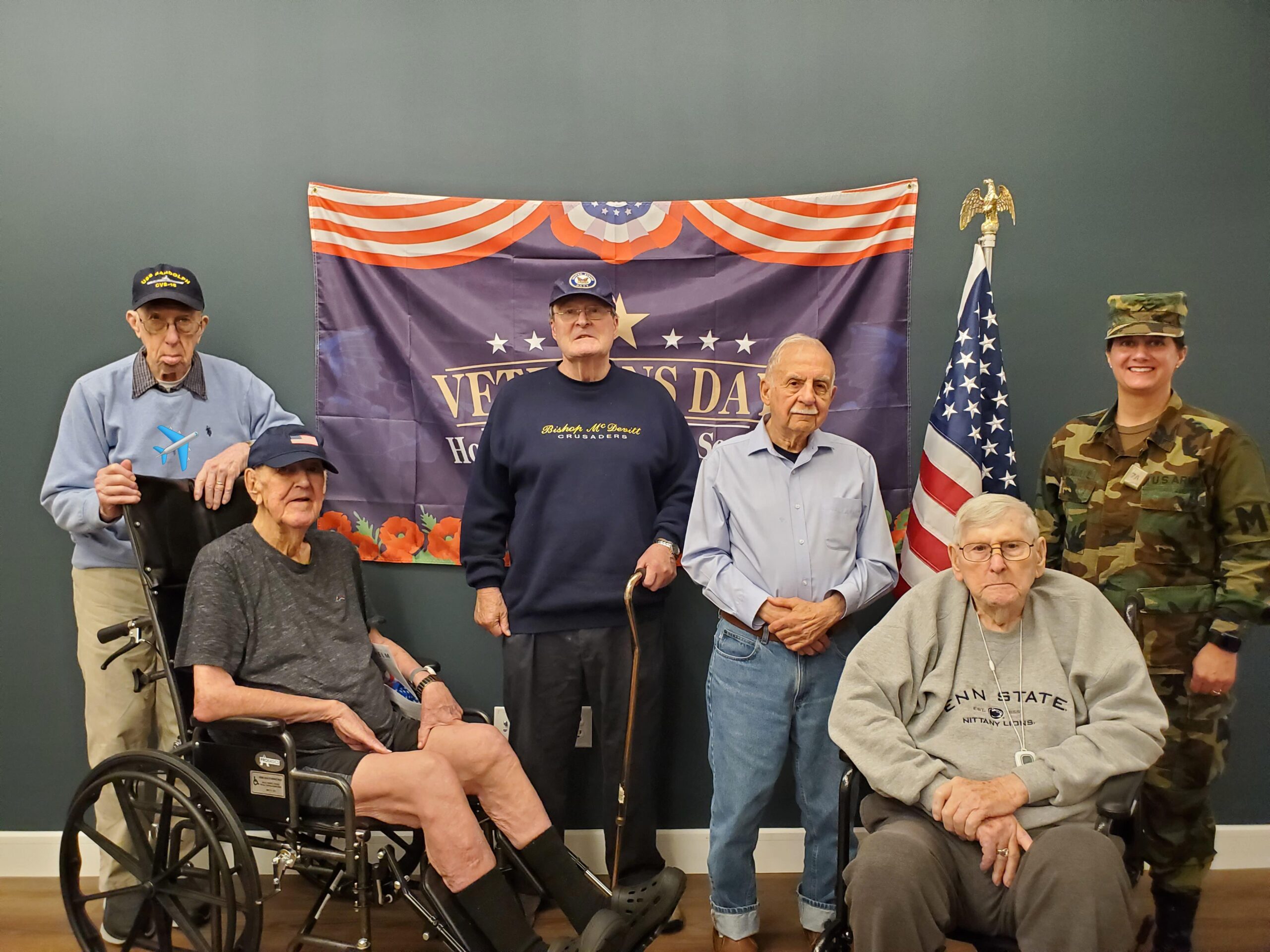 Veterans celebration with residents and a military member.
