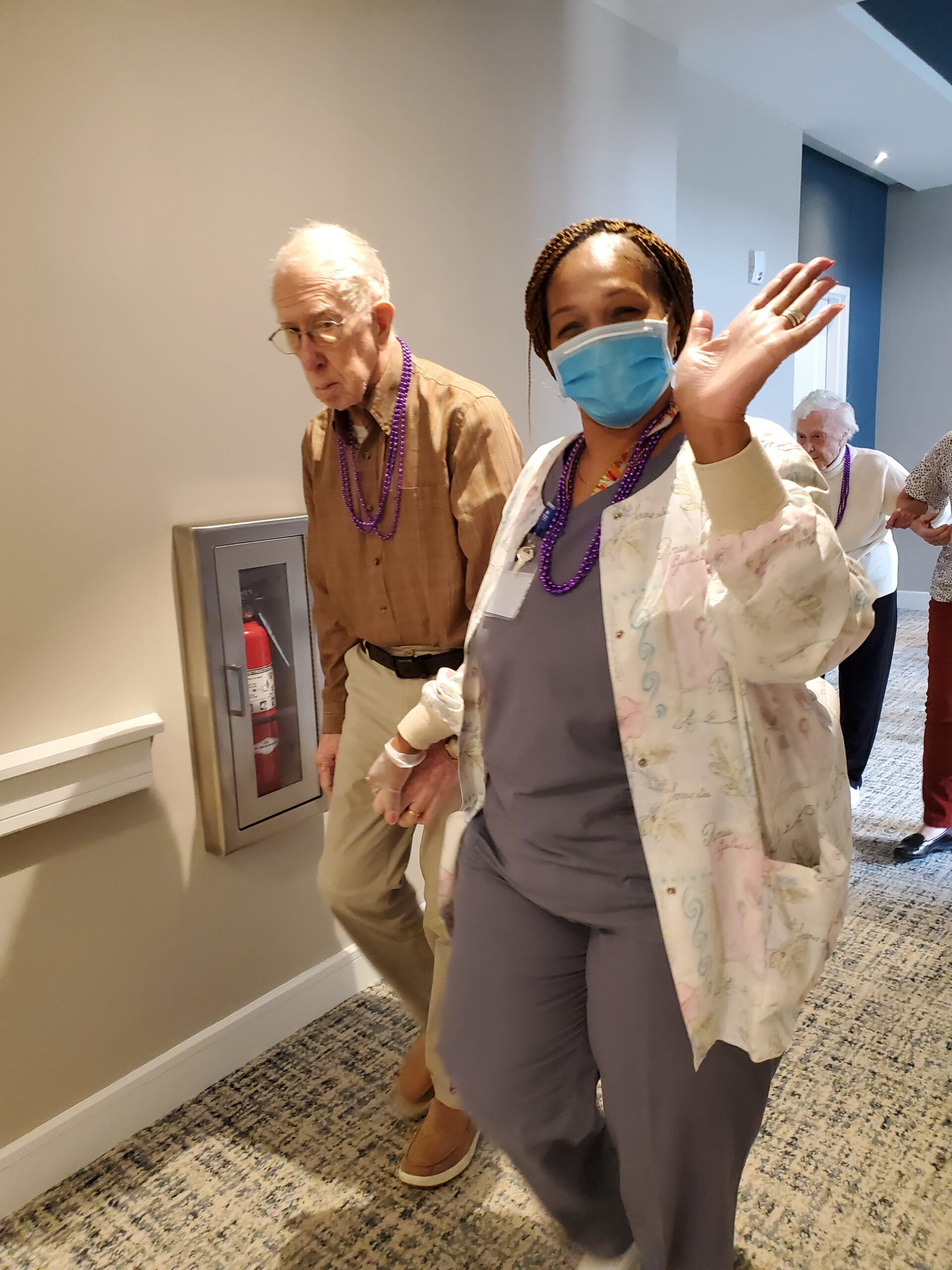 Staff member with resident in a hallway