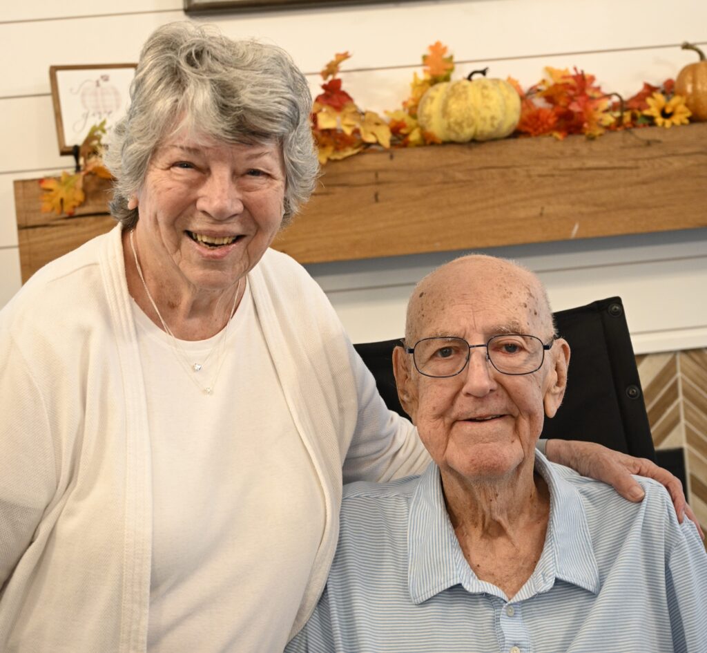 Smiling senior couple enjoying time together indoors.