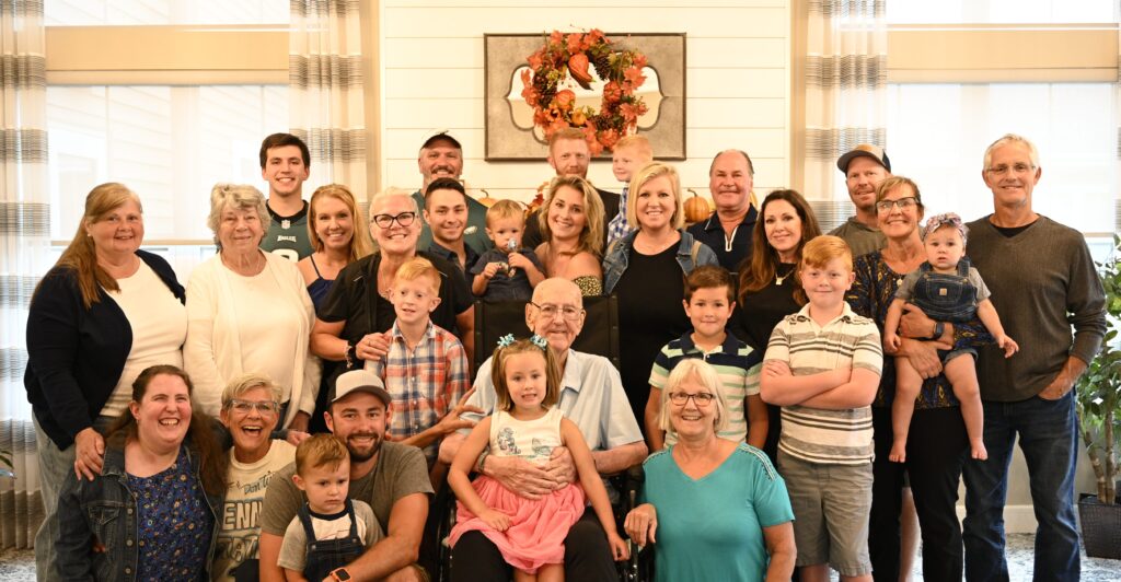 Group photo of residents and families in a common area