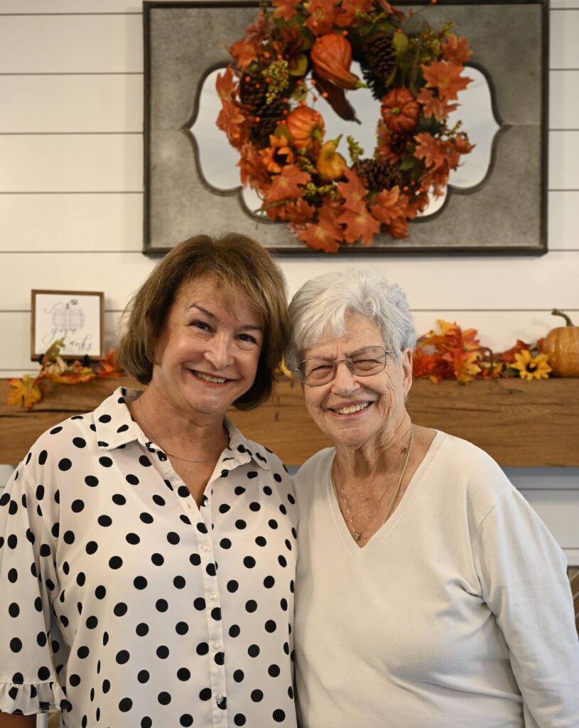 Staff member with a senior resident smiling together