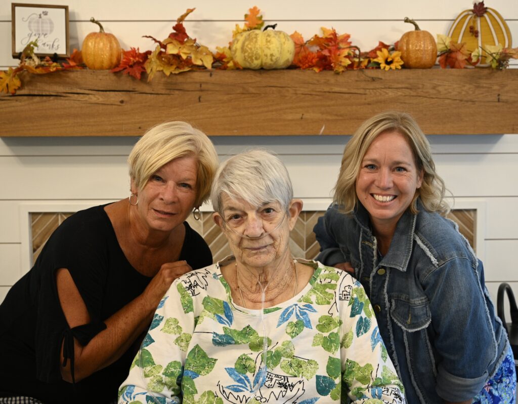 Two staff members with a resident in a cheerful setting.