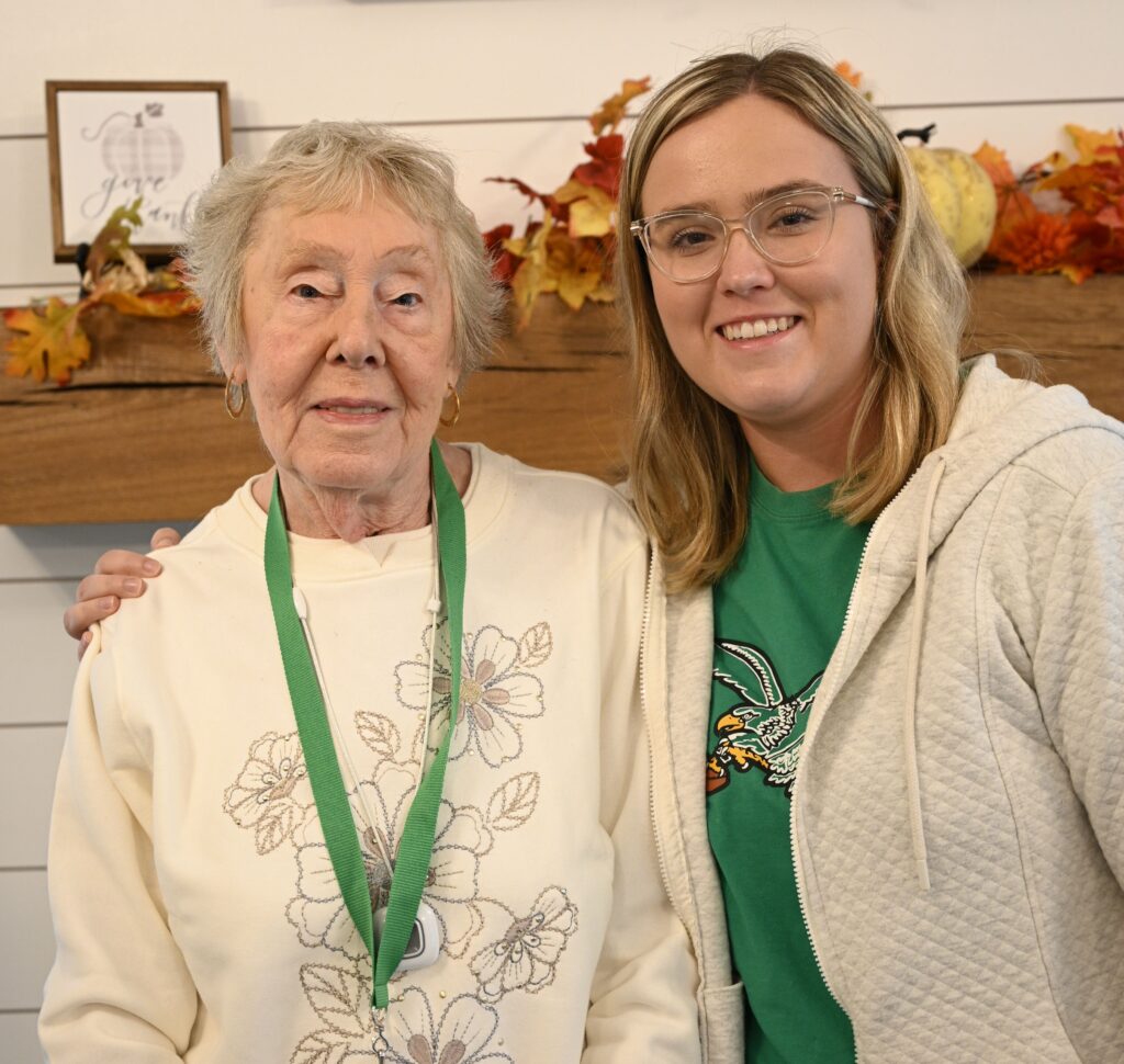 Resident with staff member in a cozy interior