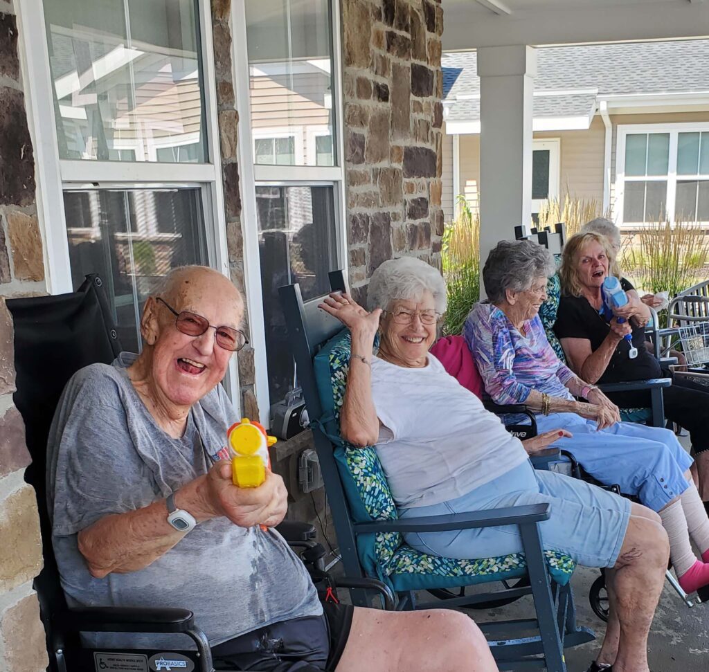 Residents enjoying time on the porch with water toys.