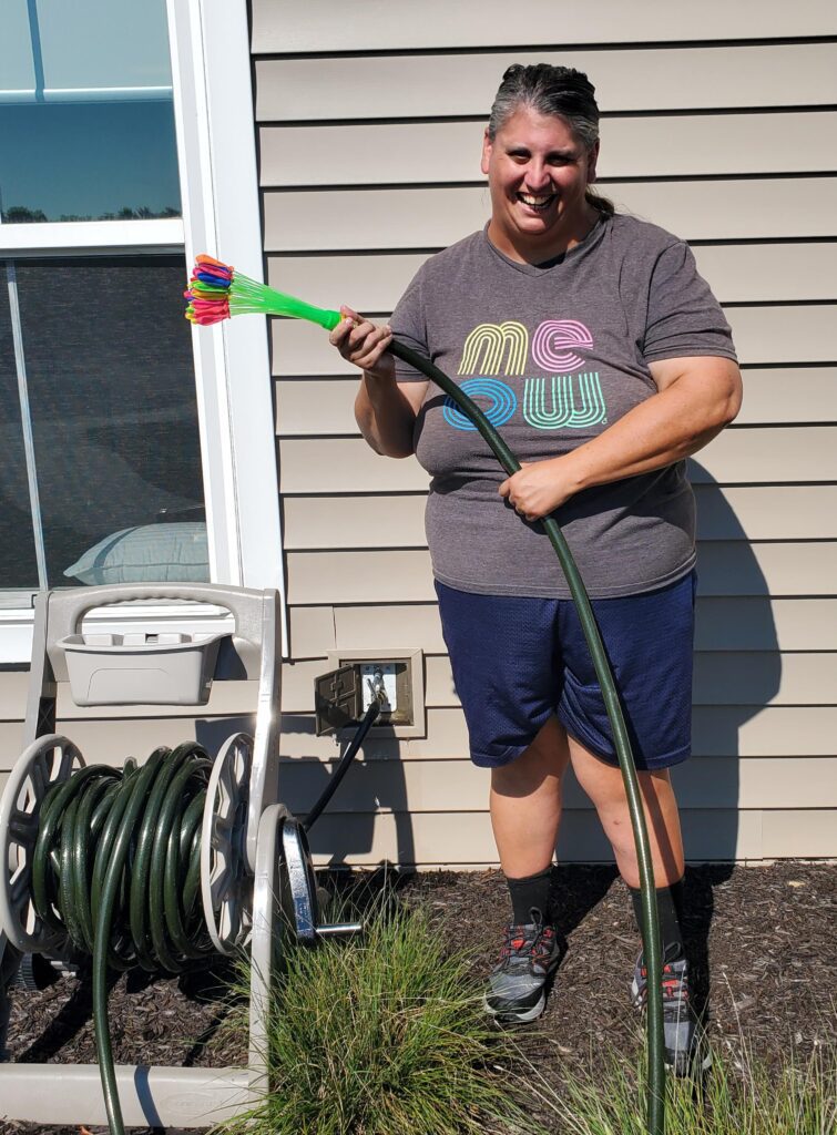 Woman with a hose in an outdoor area