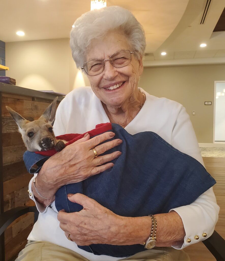 Senior resident holding a pet kangaroo