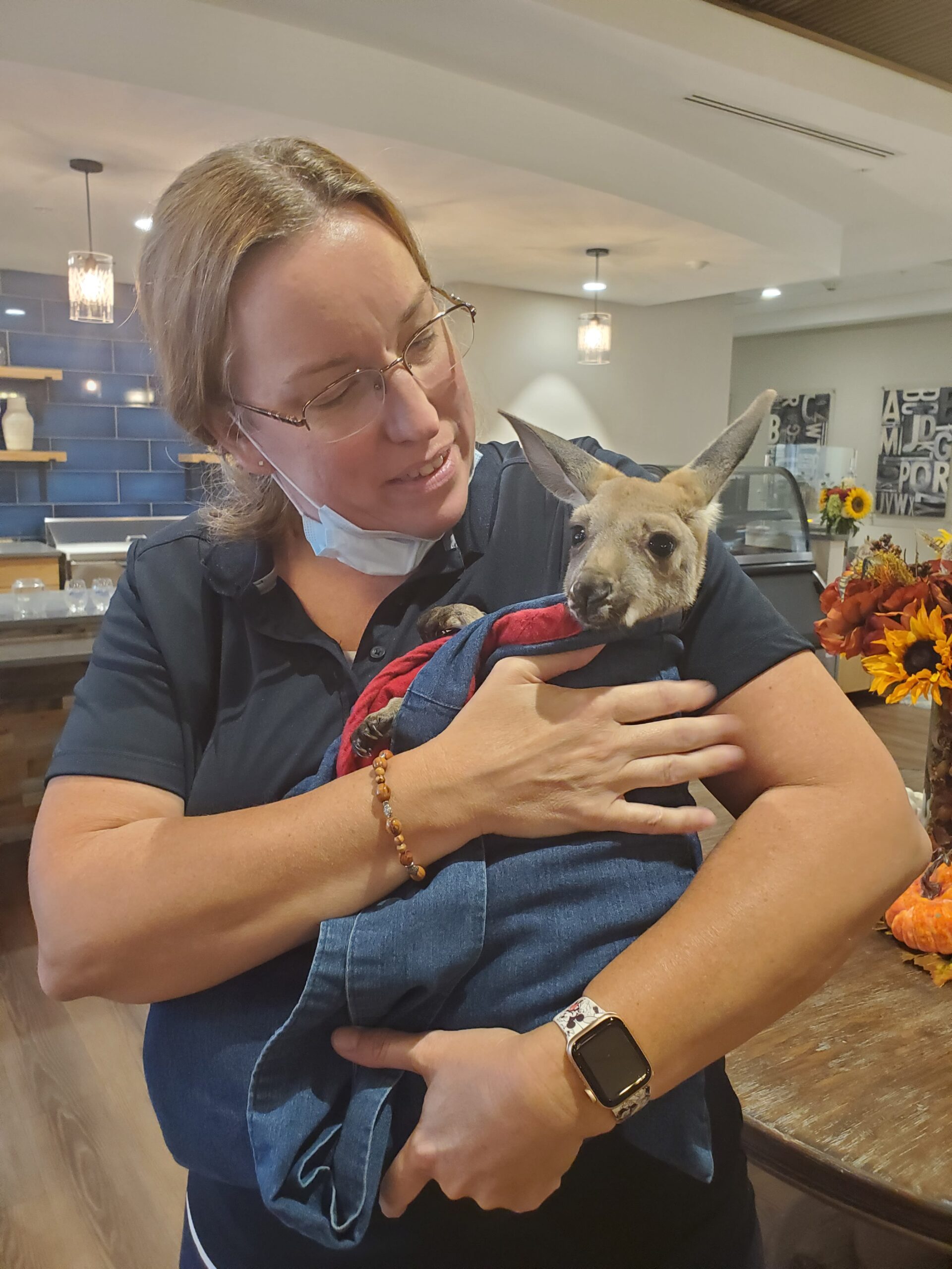 Staff member with a kangaroo at the facility