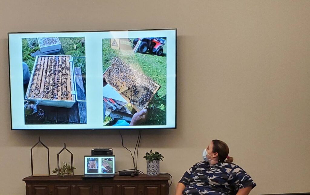 Resident engaging with a beekeeping presentation