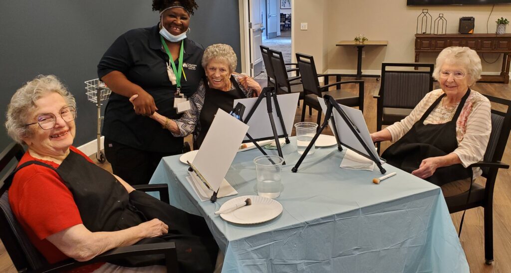 Residents enjoying an art activity in a common area.