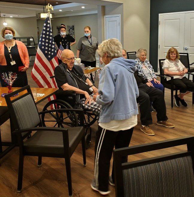 Residents and staff engaged in an indoor activity.