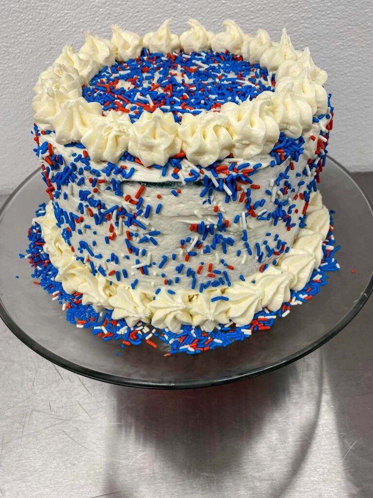 Decorative cake with red and blue sprinkles.