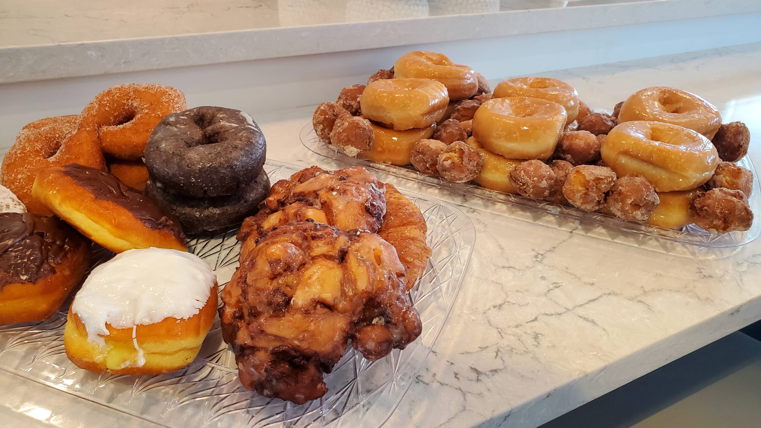 A variety of freshly baked donuts on display.