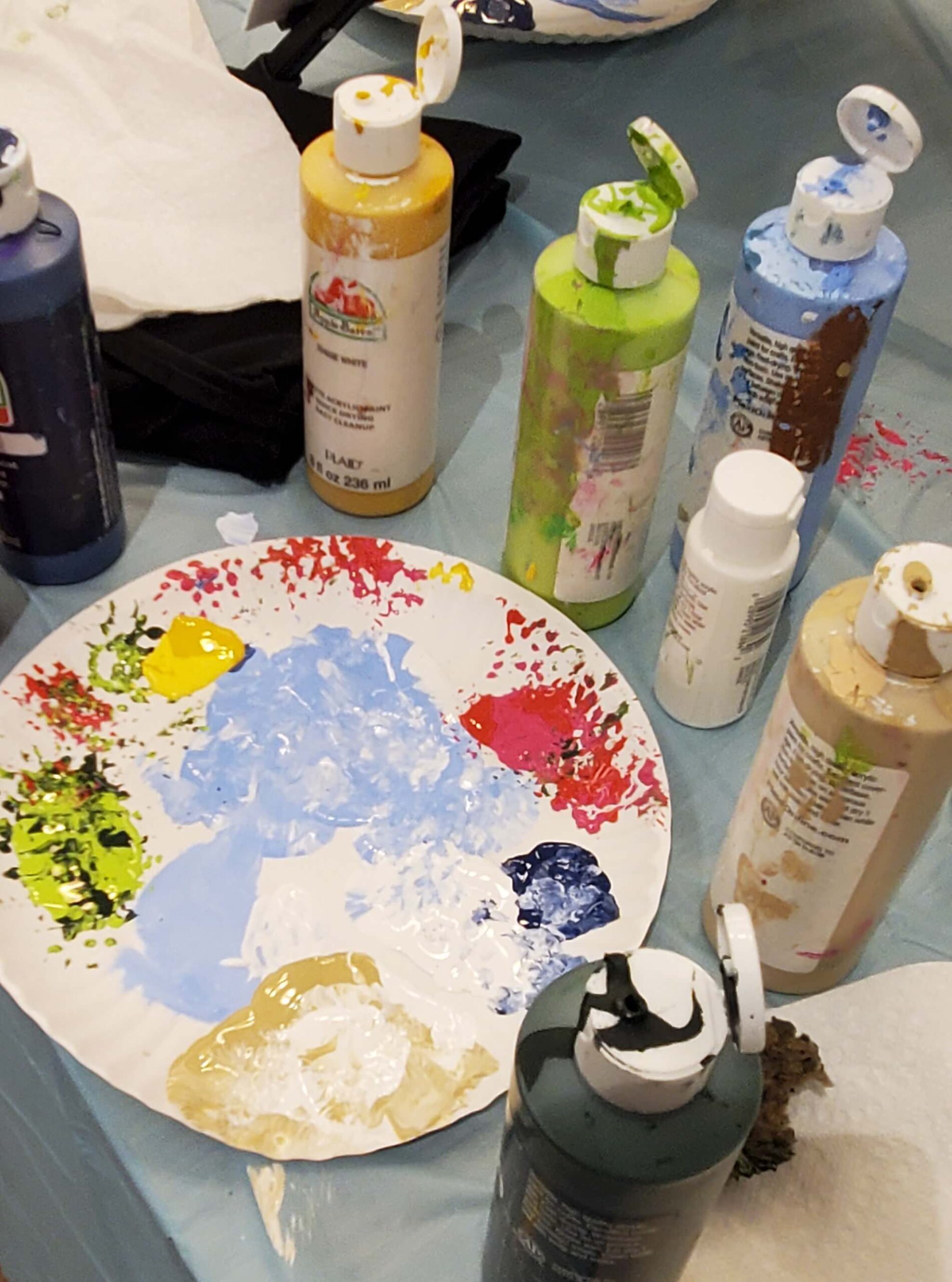 Painting supplies and colors on a table
