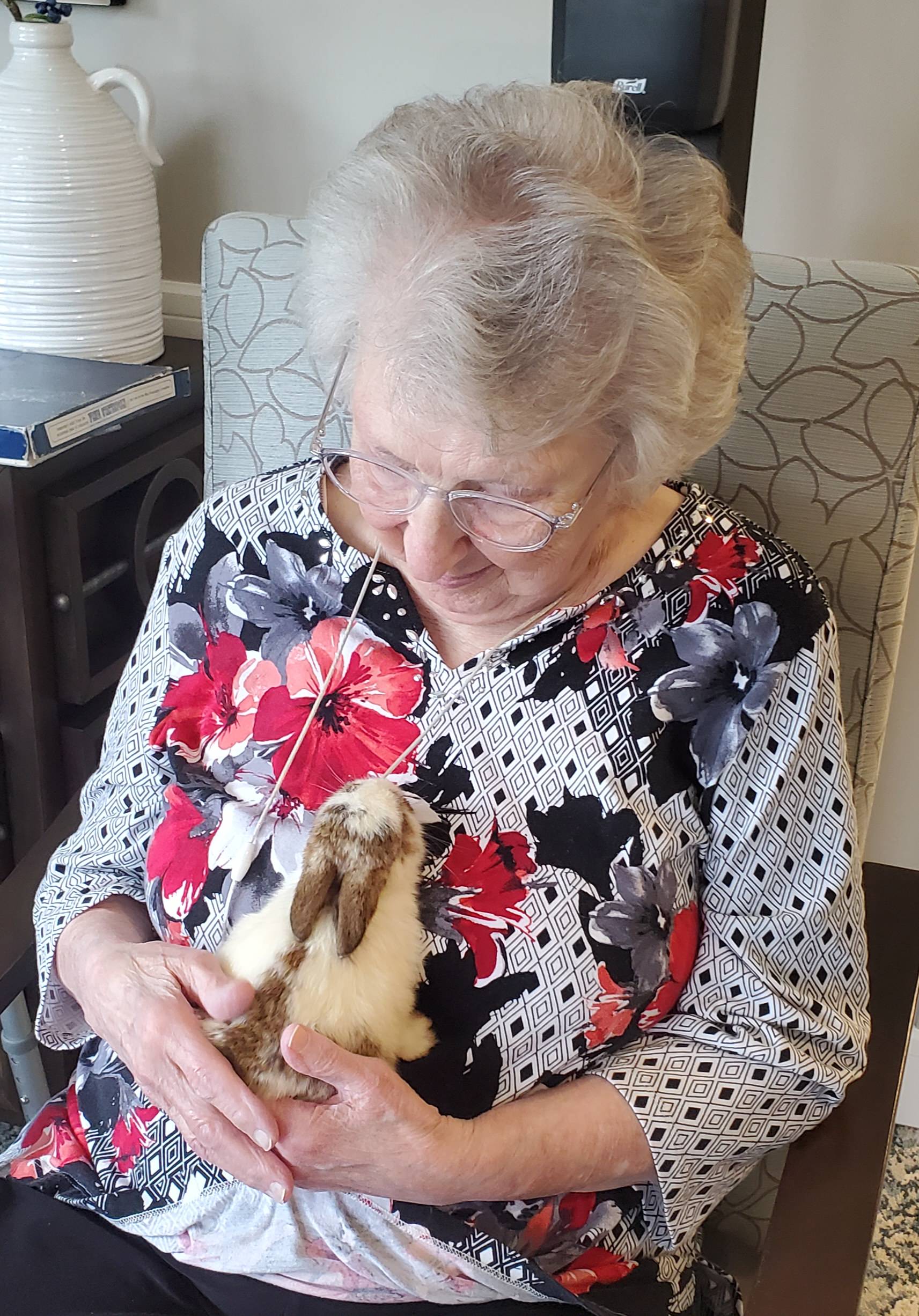 Resident holding a rabbit during a visit