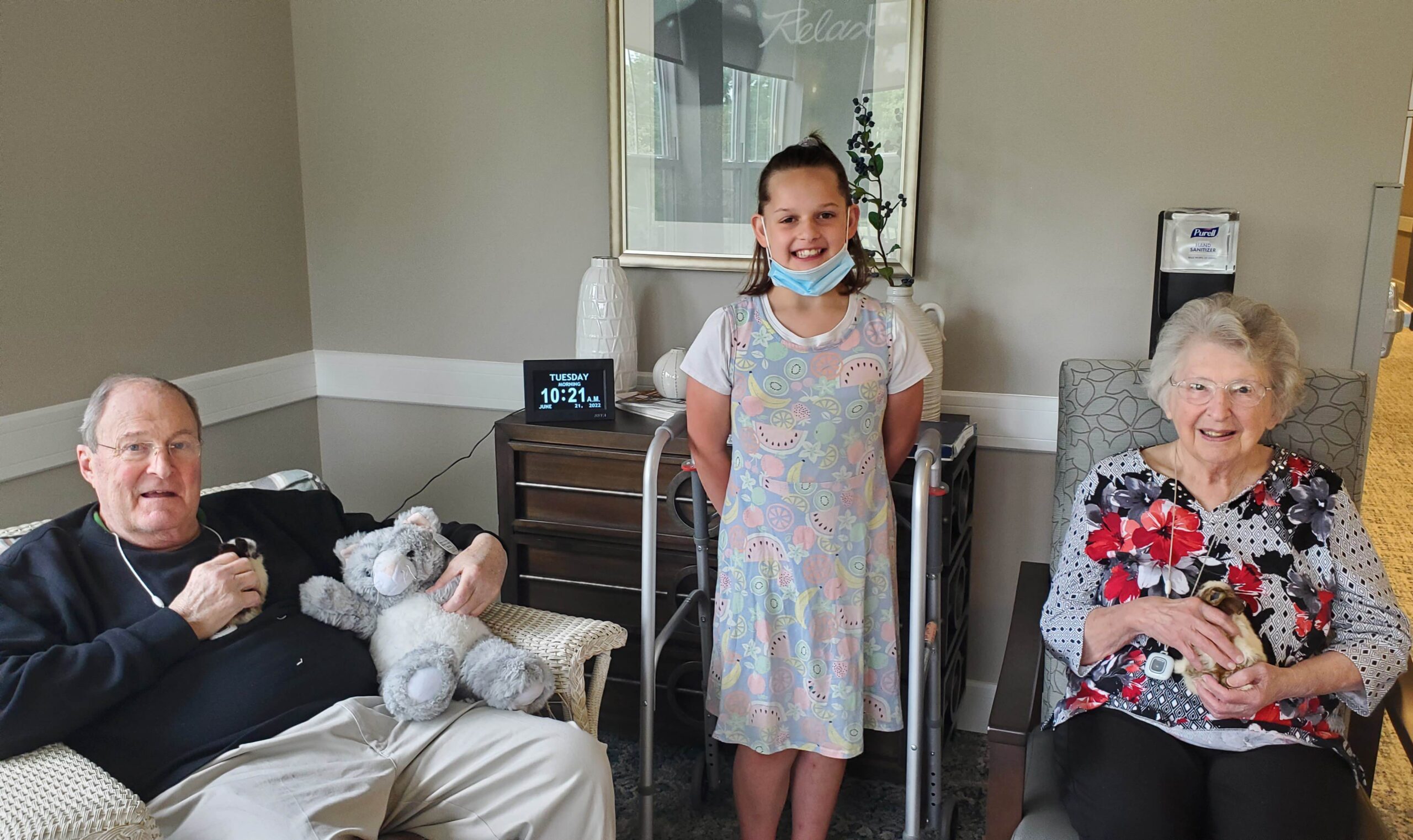 Residents and a child enjoying time together indoors.