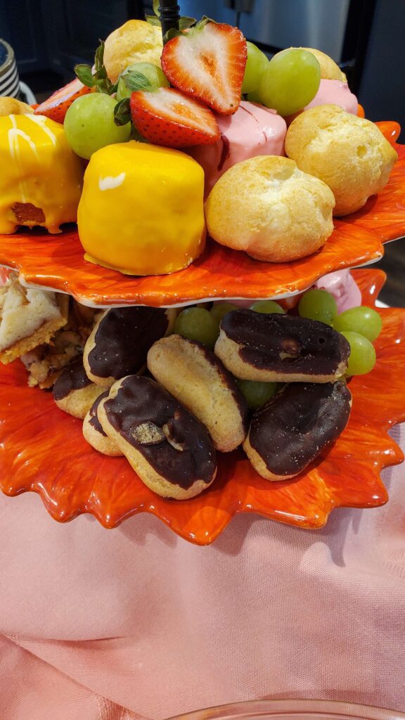 A tiered tray of assorted desserts and fruits.