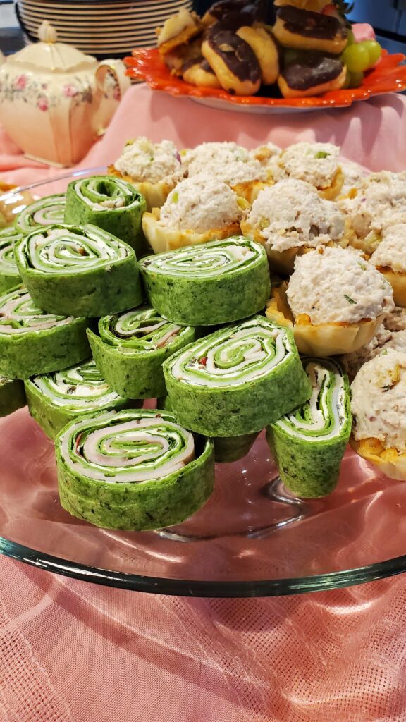 Platter of rolled sandwiches and snacks