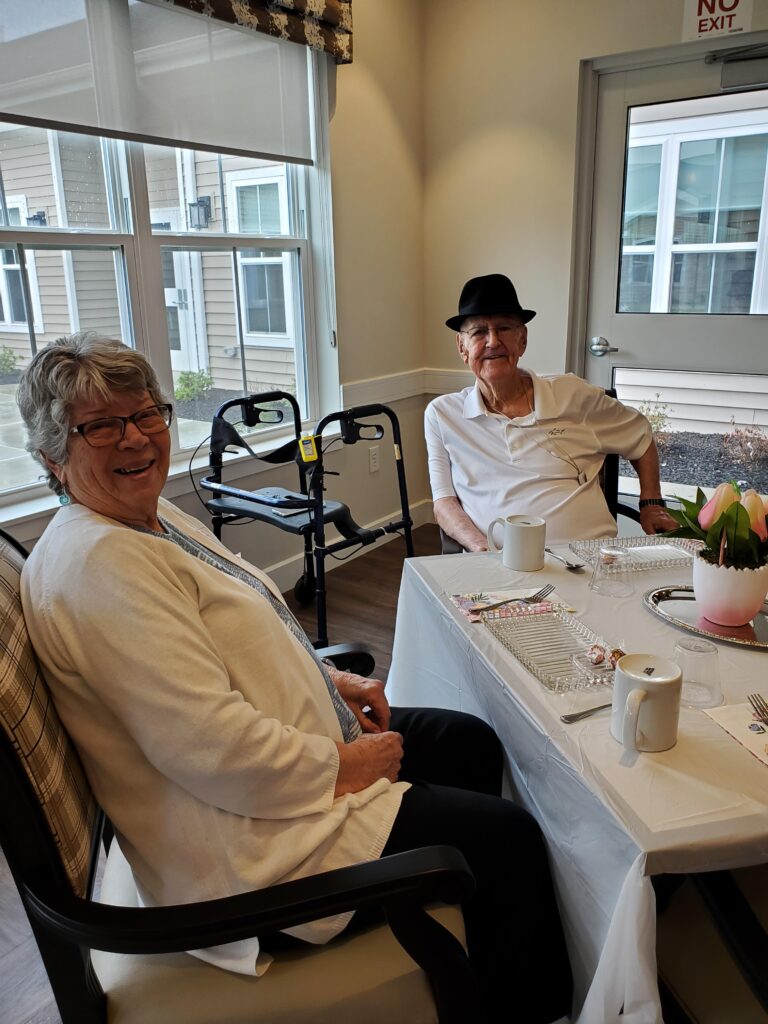 Two smiling residents in a common area