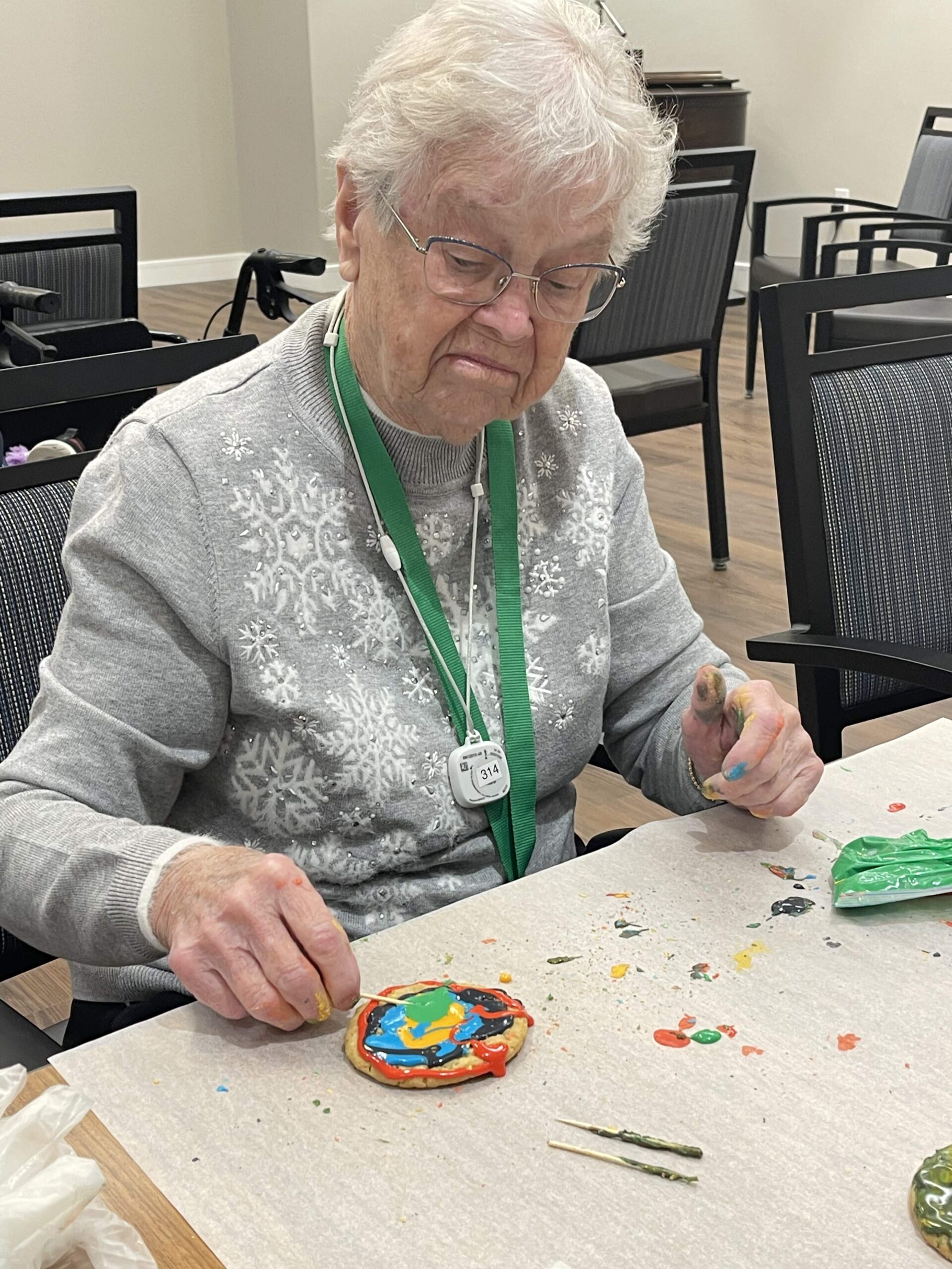 Senior resident decorating cookies during an activity