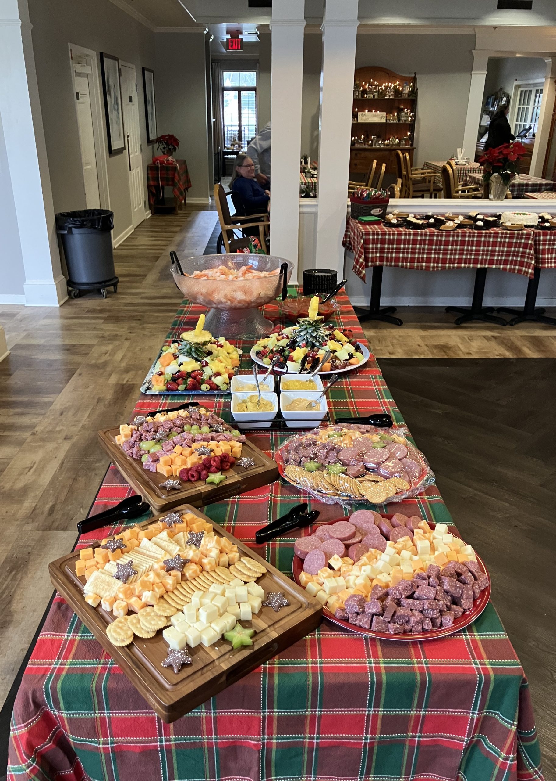A dining setup with various cheese and fruit platters.