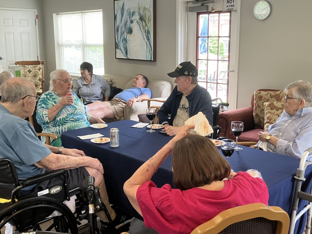 Residents socialize over snacks and drinks in a common area.