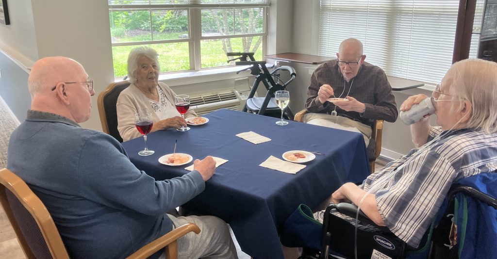 Residents enjoying snacks at a communal table