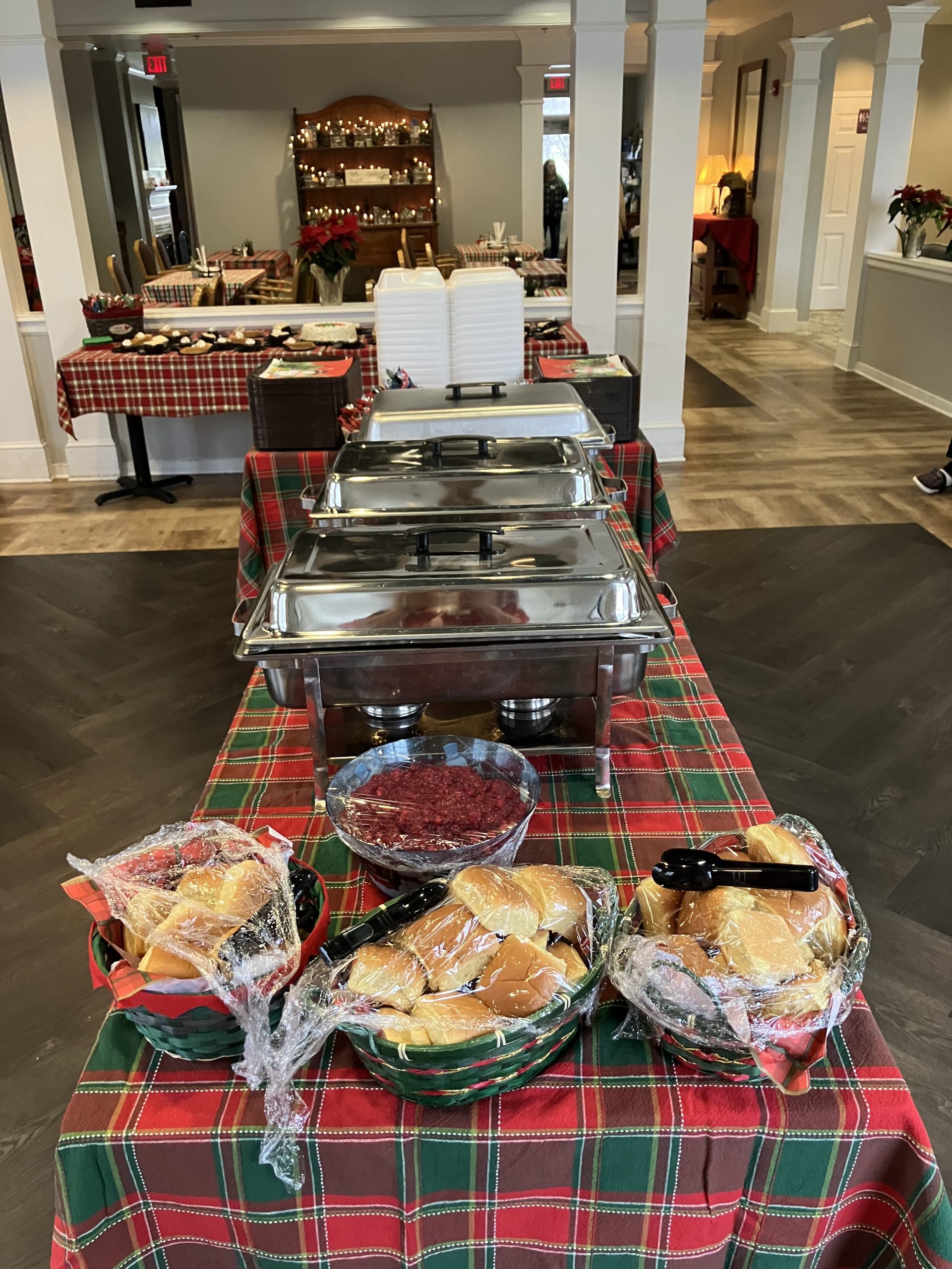 Buffet setup with rolls and cranberry sauce.