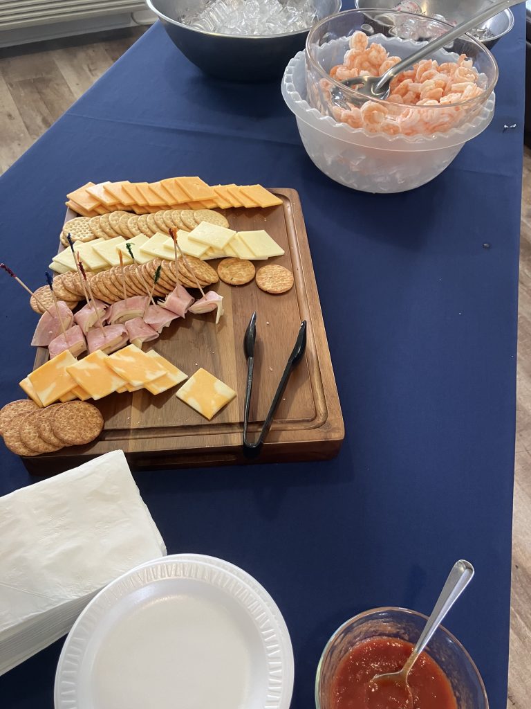 Assorted cheese, crackers, and shrimp cocktail platter