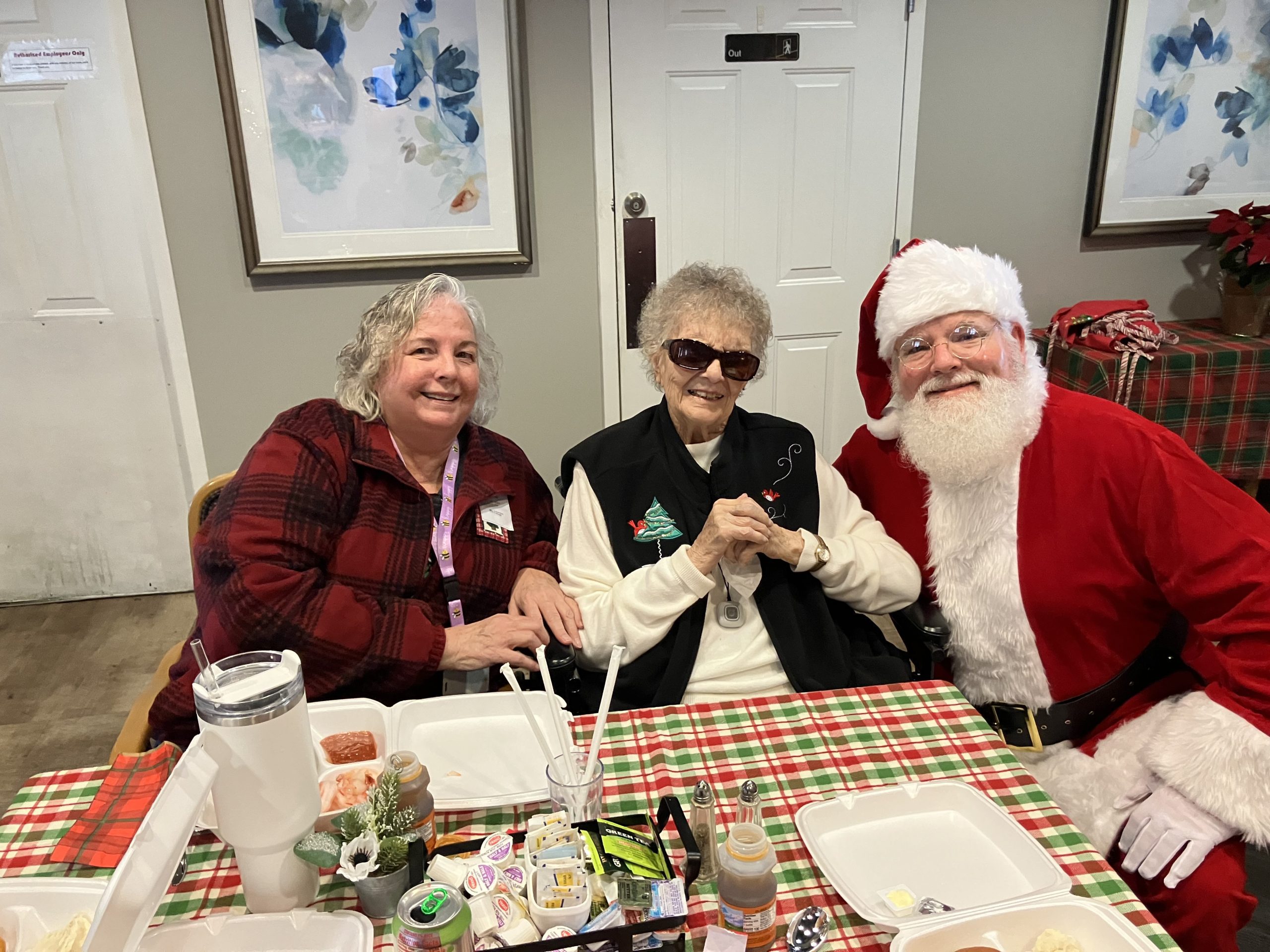 Residents and Santa celebrating together in a common area.