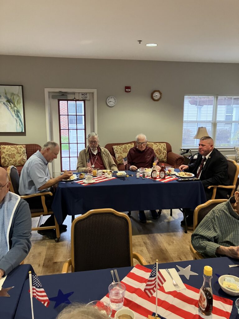 Residents enjoying a meal together at a communal table.